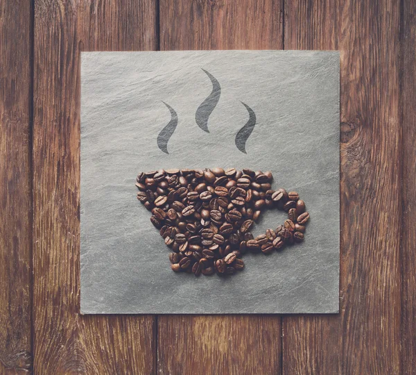 Cup from coffee beans at stone background — Stock Photo, Image