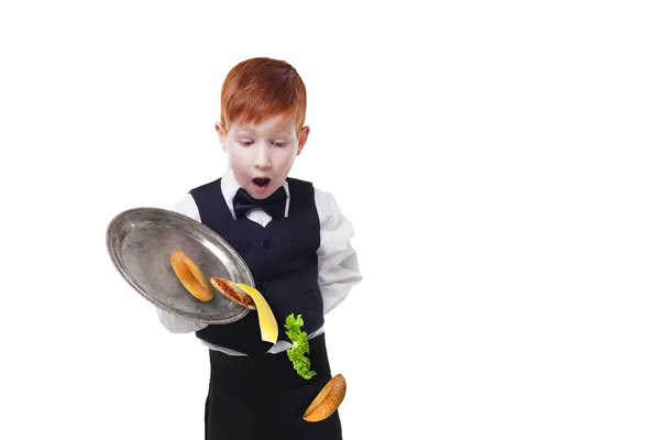 Clumsy little waiter drops food from tray while serving hamburger — Stock Photo, Image