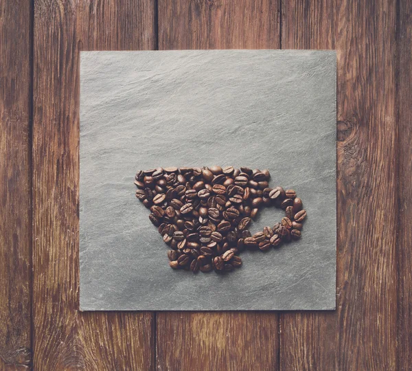 Cup from coffee beans at stone background — Stock Photo, Image