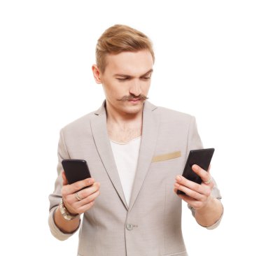Young man holding two mobile phones, make choice
