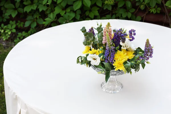 Beautiful flower bouquet outdoors. Wedding floristic decoration at white table — Stock Photo, Image