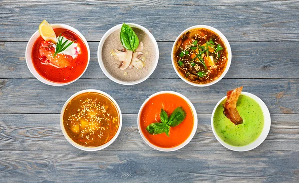 Variety of soups at blue wood, top view — Stock Image Variety of soups at blue wood, top view Stock Photo
