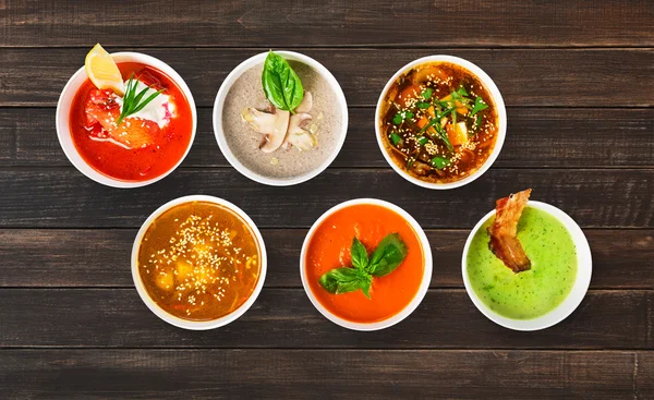 Variety of soups at brown wood, top view — Stock Image Variety of soups at brown wood, top view Stock Image