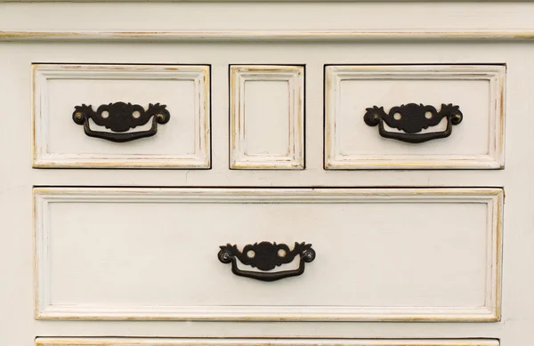 Vintage wooden chest of drawers with black metal handles open — Stock Photo, Image