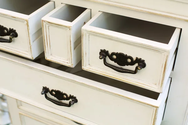 Vintage wooden chest of drawers with black metal handles open — Stock Photo, Image