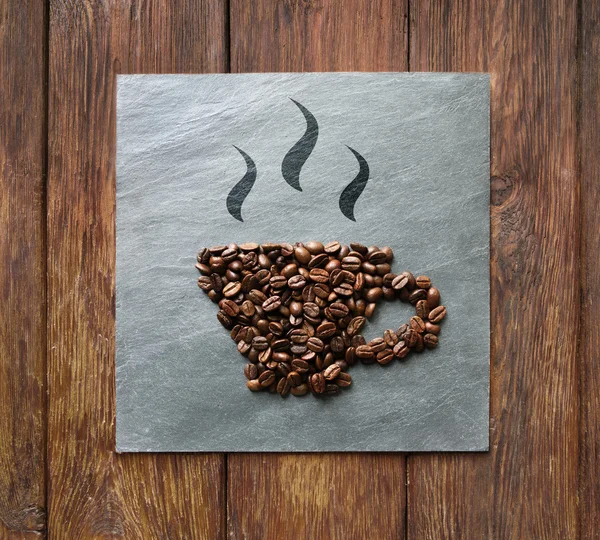 Cup from coffee beans at stone background — Stock Photo, Image