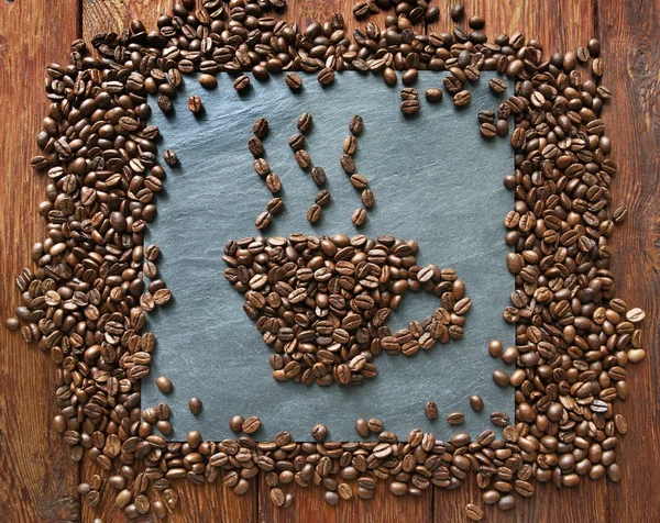 Cup from coffee beans at stone background — Stock Photo, Image
