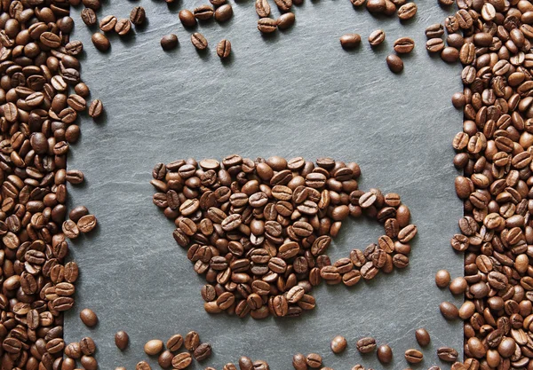 Cup from coffee beans at stone background — Stock Photo, Image