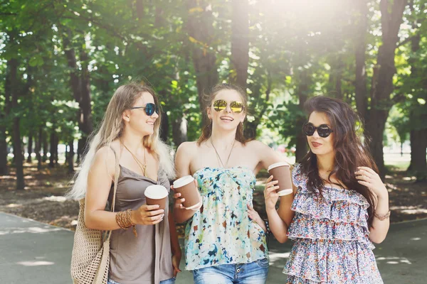 Three beautiful young boho chic stylish girls walking in park. — Stock Photo, Image