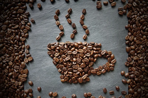 Cup from coffee beans at stone background — Stock Photo, Image