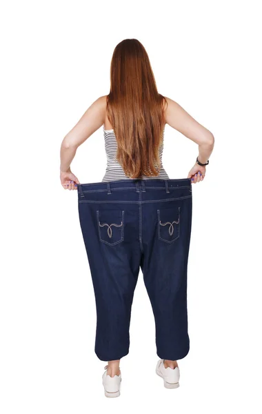 Młoda kobieta szczęśliwa z wyniki weight loss diet, na białym tle — Zdjęcie stockowe