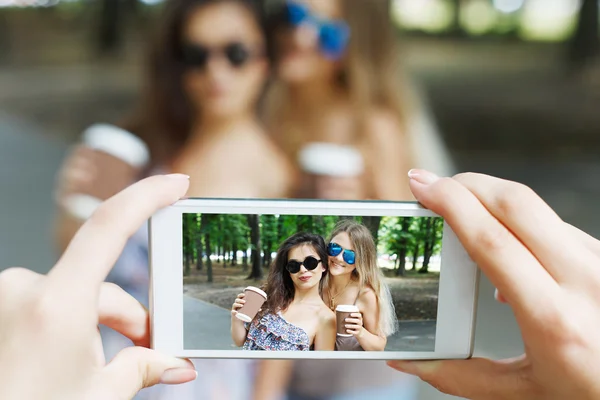 Chicas amigas tomando fotos con smartphone al aire libre — Foto de Stock