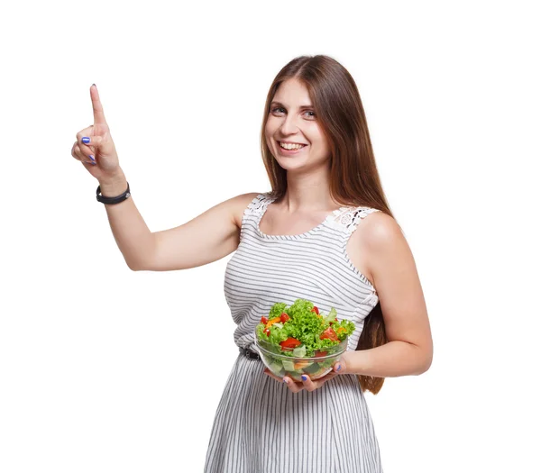 Gülümseyen kadın sebze salatası tutun ve hayali ekrana dokunun — Stok fotoğraf