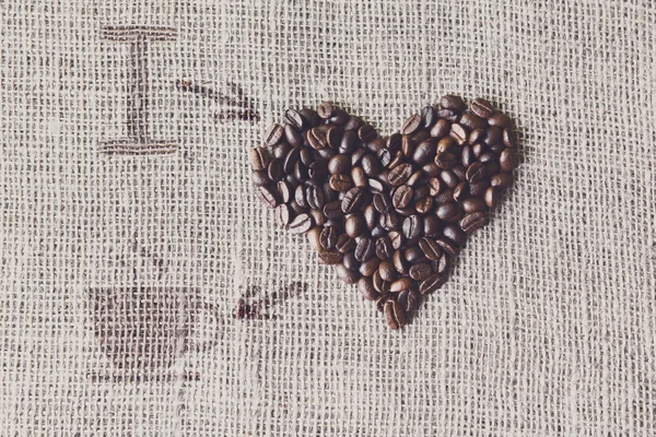 Love to coffee - Burlap texture with beans heart shape — Stock Photo, Image