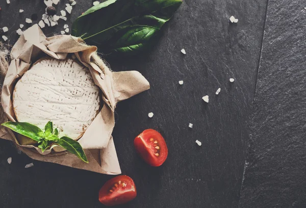 Cheese delikatessen with chili on black stone, brie camembert — Stock Photo, Image