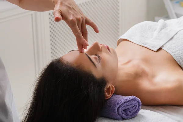 Woman massagist make face lifting massage in spa wellness center — Stock Photo, Image