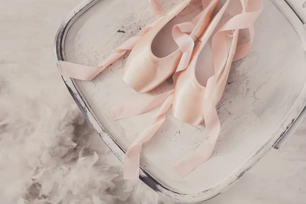 Zapatillas y plumas de ballet rosa sobre fondo de madera blanca —  Fotos de Stock