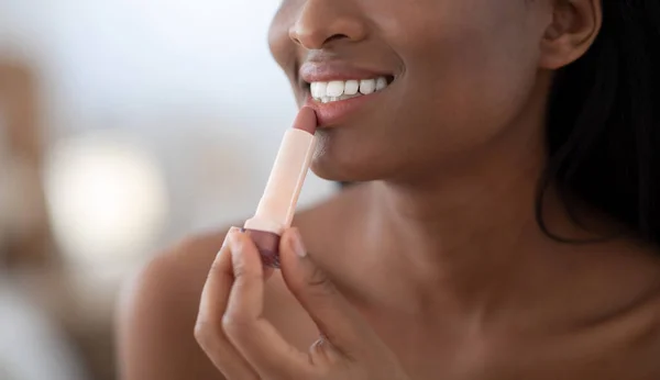Smiling young beautiful african american lady applying nude color lipstick on lips get ready in morning — Stock Photo, Image