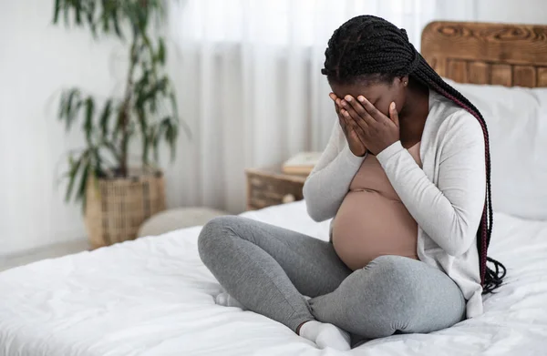 Triste preto grávida mulher chorando em casa, tendo maternidade depressão — Fotografia de Stock