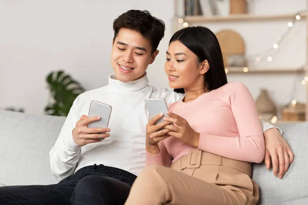 Couple asiatique utilisant des téléphones intelligents Navigation sur Internet Sitting At Home — Photo