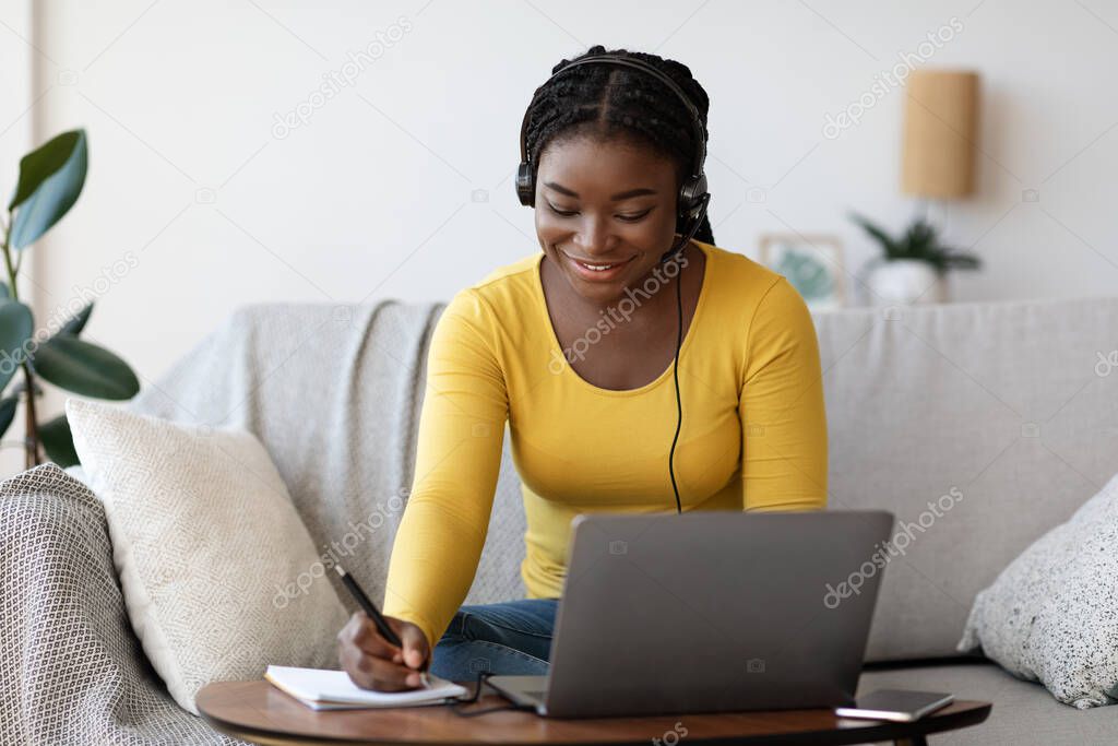 Online Education. Smiling Black Woman In Headset Studying With Laptop At Home