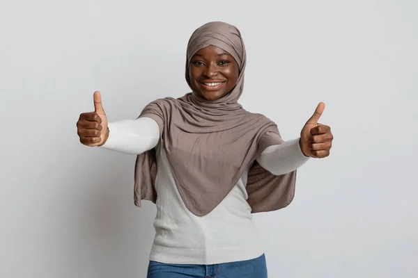 Όπως. Χαρούμενη μαύρη μουσουλμάνα με μαντίλα που δείχνει τους αντίχειρες στην κάμερα. — Φωτογραφία Αρχείου