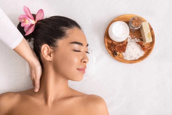 Nyugodt ázsiai nő élvezi a nyak masszázs természetes összetevők kozmetikumok spa — Stock Fotó