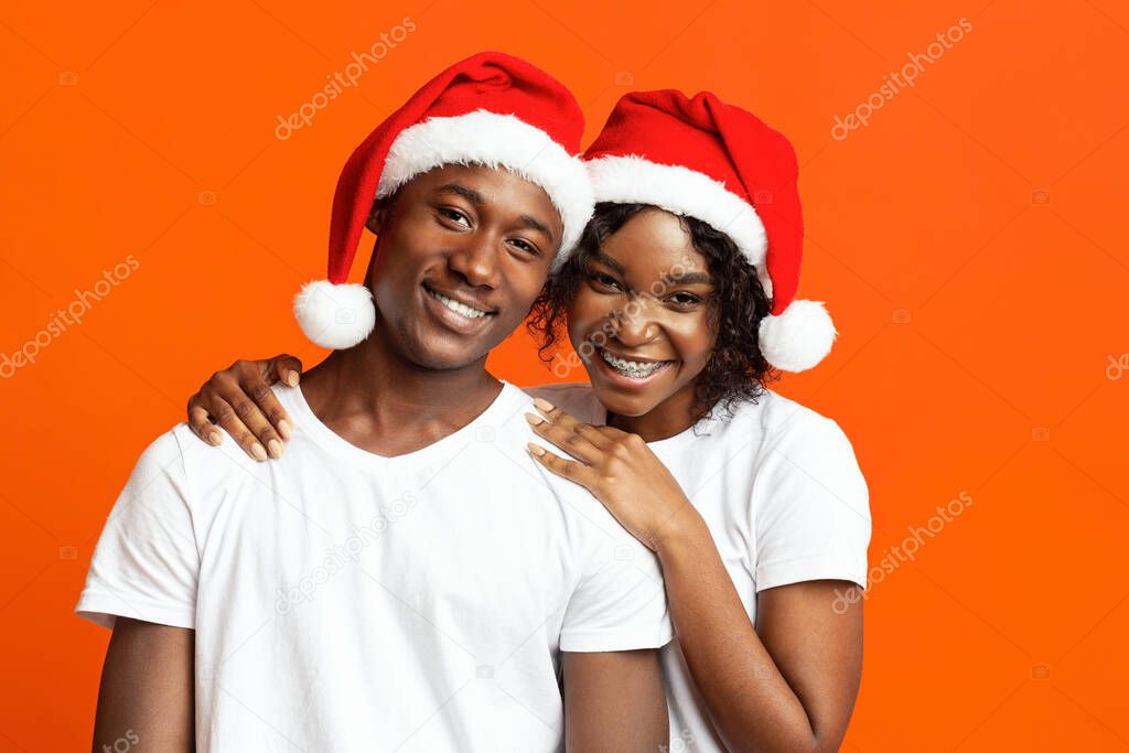 Cheerful black couple in love celebrating New Year together