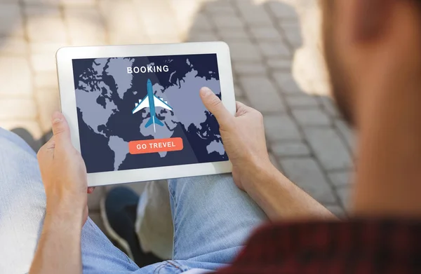 Booking go travel. Guy use tablet with mobile map and airplane application for buying tickets on screen — Stock Photo, Image