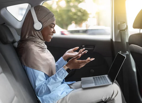Online Communication. Black Muslim Woman Having Video Conference Via Laptop In Car