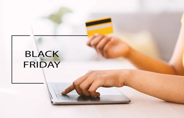 Black friday. Woman using laptop and credit card at home — Stock Photo, Image