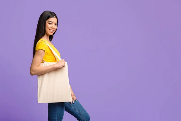 Young Asian Woman With Blank Tote Canvas Shopping Bag Posing Over Purple Background — Stock Photo, Image