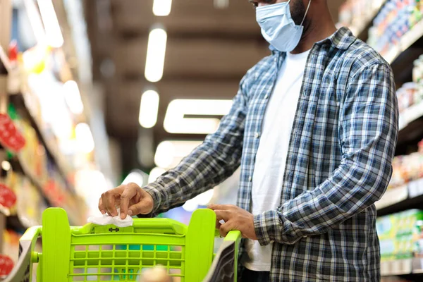 Black Man Disinfecting Shopping Cart In Supermarket Shopping Grocery Food