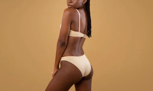 Junge schlanke schwarze Frau in Unterwäsche mit Dehnungsstreifen am Körper, beschnitten — Stockfoto