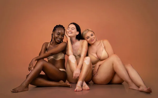 Group of women with different body types and ethnicity sitting in underwear — Stock Photo, Image