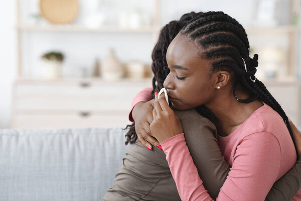 Unrecognizable african american lady comforting her upset friend