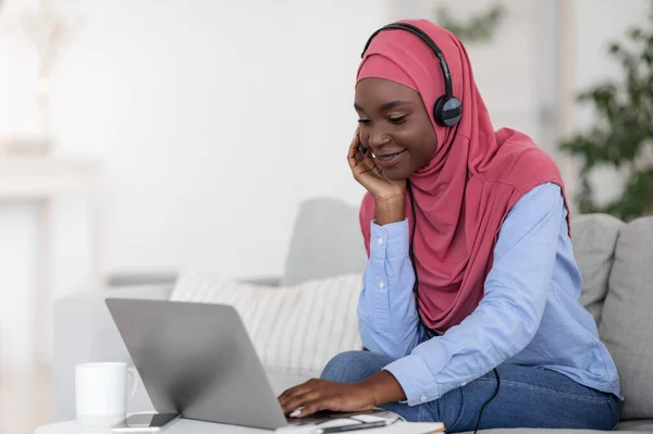 Pozitív fekete muszlim hölgy néz webinar laptopon, tanul otthon — Stock Fotó