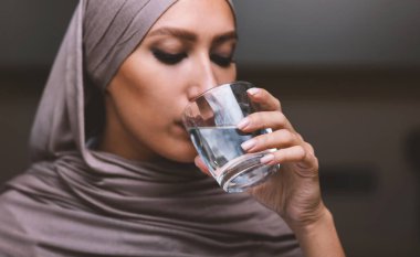 Mutfakta bardaktan su içen Arap kadının portresi