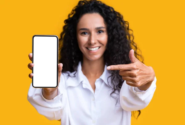 Mockup Image Of Brunette Woman Pointing At Smartphone With Blank White Screen — Stock Photo, Image
