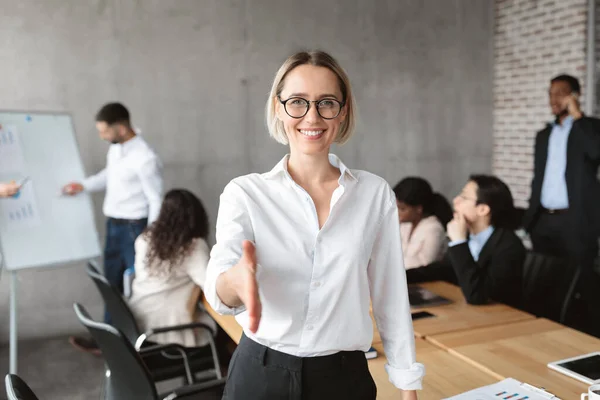 Businesswoman Stretching Hand For Handshake To Camera Standing In Office — Stock fotografie