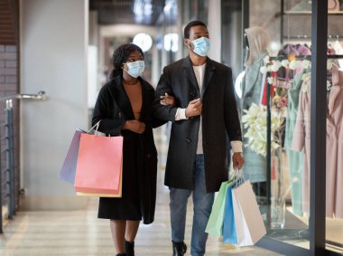 Bir çift dükkan penceresinin önünden geçip içeri bakıyor.