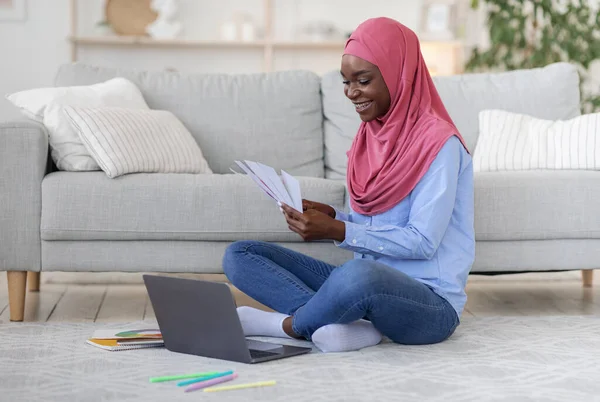 Happy Black Muslim Female Interior Designer Working Remotely With Laptop At Home