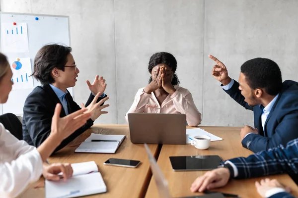 Discontented Coworkers Shouting At Unhappy Victimized Businesswoman In Office