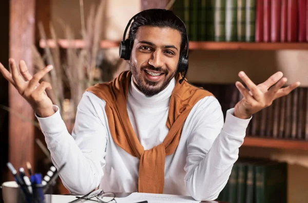 Smiling Arab Teacher Talking To Camera Teaching Online At Home
