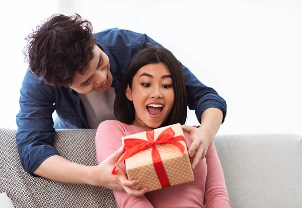 Asian Husband Giving Wrapped Christmas Gift To Wife At Home — Stock Photo, Image