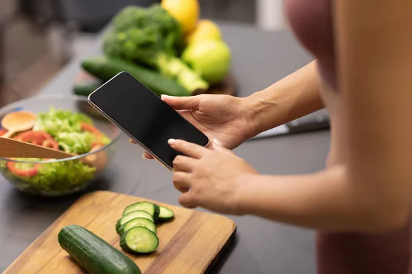 Lady Using Phone Searching Recipes For Weight-Loss In Kitchen, Cropped