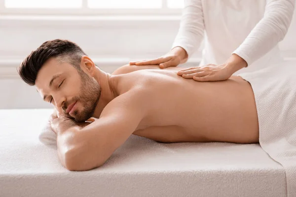 Relajado hombre de negocios teniendo masaje en el spa después del día de trabajo — Foto de Stock