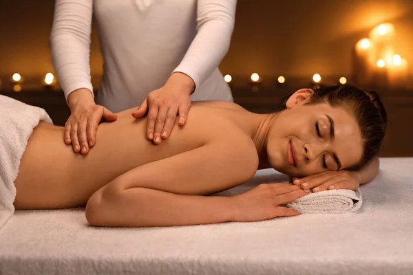 Woman having body massage session at modern spa