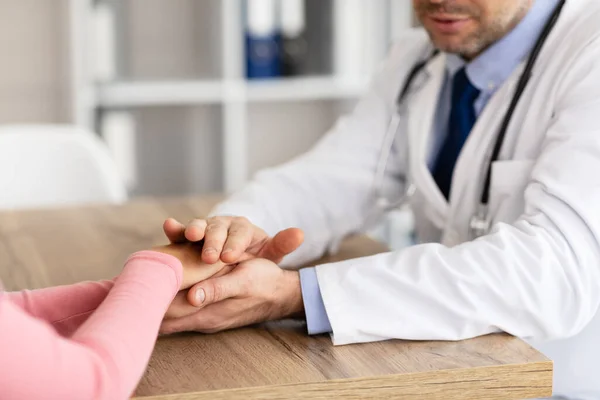 Close up of male doctor holding female patients hands — Stock Photo, Image