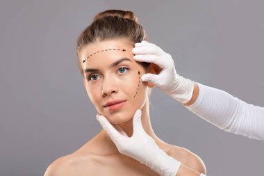 Yüzünde yara izleri olan genç bayan güzellik kliniğinde tedavi görüyor.